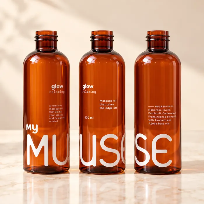 Three amber cosmetic bottles round printed in white with the My Muse label