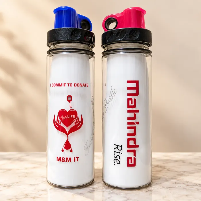 Two clear sipper bottles round printed with Mahindra Rise and a donation message